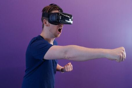 Virtual Reality - Man Punching in the Air while in VR Goggles