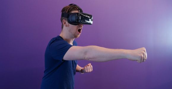 Virtual Reality - Man Punching in the Air while in VR Goggles