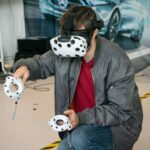 Virtual Reality And Augmented Reality - man in black jacket and blue denim jeans with white and black panda mask