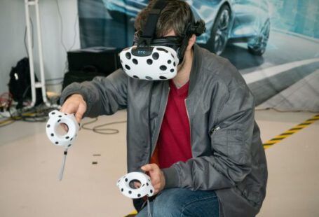 Virtual Reality And Augmented Reality - man in black jacket and blue denim jeans with white and black panda mask