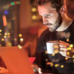 Internet Of Things - Man Holding Mug in Front of Laptop