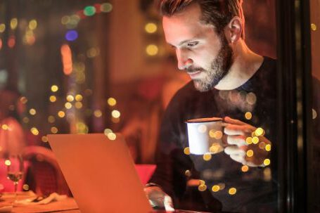 Internet Of Things - Man Holding Mug in Front of Laptop