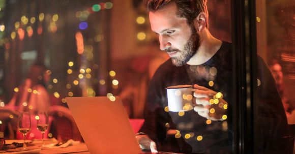 Internet Of Things - Man Holding Mug in Front of Laptop