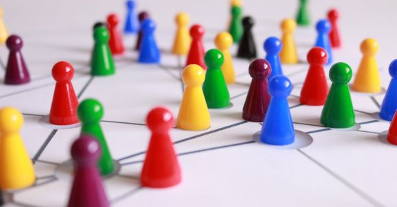 Teamwork - Close Up Photography of Yellow Green Red and Brown Plastic Cones on White Lined Surface