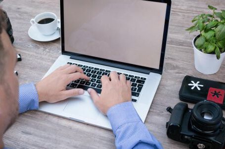Software - Person Using Macbook Pro Beside Dslr Camera