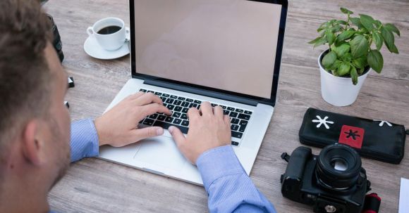 Software - Person Using Macbook Pro Beside Dslr Camera