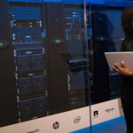 Server - Software Engineer Standing Beside Server Racks