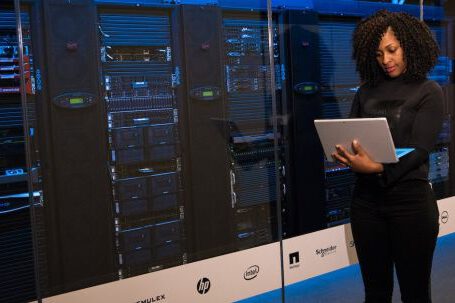 Server - Software Engineer Standing Beside Server Racks