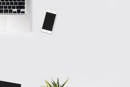 Technology - White Smartphone Beside Silver Laptop Computer