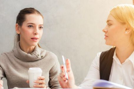 Career - Two Women Holding Pen