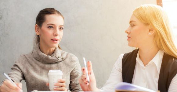 Career - Two Women Holding Pen