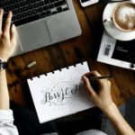 Web Design - Person Sitting Facing Laptop Computer With Sketch Pad