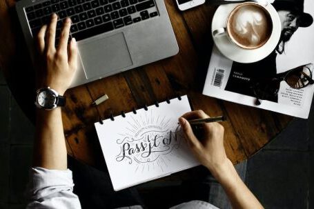 Web Design - Person Sitting Facing Laptop Computer With Sketch Pad