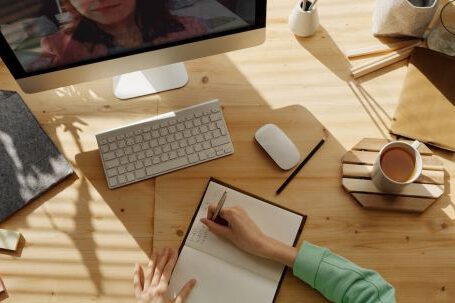 Video Conference - Person Writing on Notebook