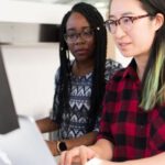 Software - Woman Wearing Red and Black Checkered Blouse Using Macbook