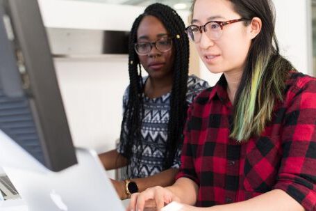 Software - Woman Wearing Red and Black Checkered Blouse Using Macbook