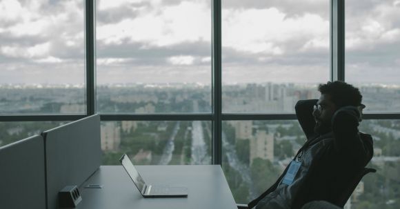 Cybersecurity - Man Reclining and Looking at his Laptop