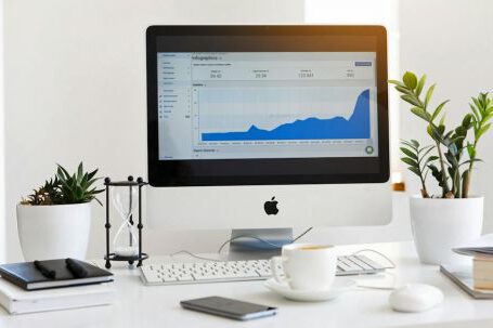 Technology - Silver Imac Displaying Line Graph Placed on Desk