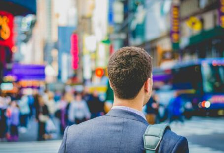 Career - shallow focus photography of man in suit jacket's back