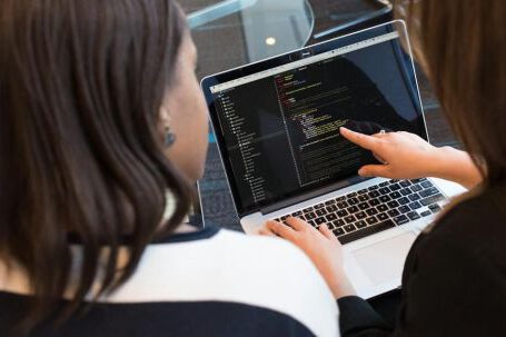 Coding - Two Women Looking at the Code at Laptop