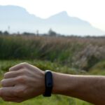 Fitness Tracker - man looking at black fitness tracker