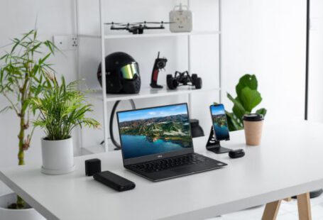 Gadgets - black laptop computer on white table