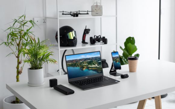 Gadgets - black laptop computer on white table